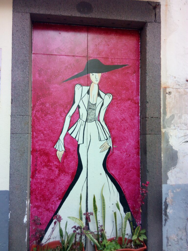 malované dveře s paní v bílých šatech a černém klobouku s červeným pozadím
